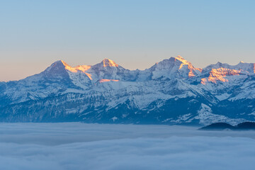 Swiss mountains evening with snow and fog