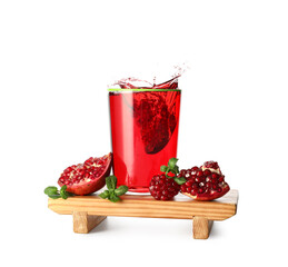 Glass of delicious pomegranate juice with splashes on white background