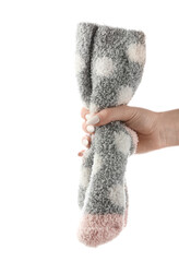 Woman holding pair of socks on white background