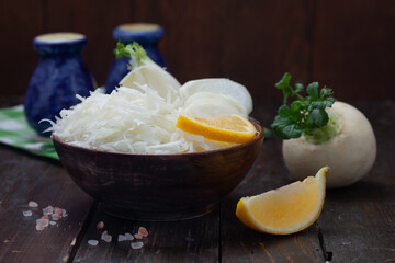 Raw white turnips salad in wooden bowl. Tasty fresh salad made of white  japanese radish. Healthy, vegetarian food.