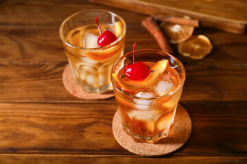 Glasses of tasty Old Fashioned Cocktail on wooden background