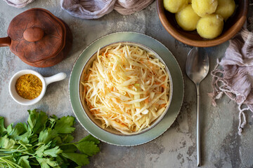 Vegetarian dish: cabbage and carrot salad in a beautiful plate for lunch on a gray background. Top...