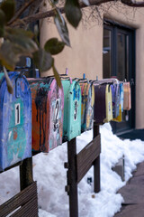 Colorful mailboxes lined in a row with snowy background