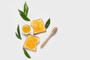Composition with tasty orange jam and toasts on white background