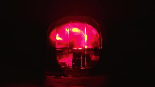 Warning alarm siren rotating and blinking at dark