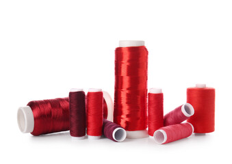 Different sewing thread spools on white background