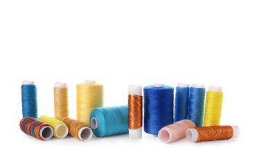 Different sewing thread spools on white background