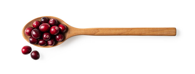 Red ripe cranberries in a large wooden spoon isolated on a white background. Wooden jam spoon full...