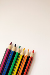 Pencils colorful as the LGBTQ+ pride flag, vertical with copy space