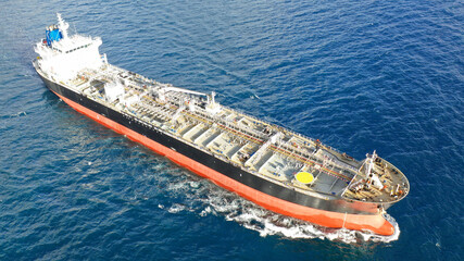 Aerial drone top view photo of oil - petrochemical tanker cruising deep blue open ocean sea