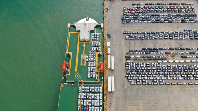 Aerial drone top down photo of large car carrier ro ro vessel anchored in car terminal of Mediterranean port