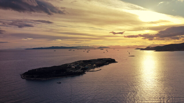 Aerial drone photo from island of Psitaleia the largest sewage treatment plant in Europe, Saronic gulf at sunset, Peiraeus, Attica, Greece