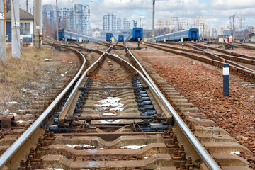 Railway automatic arrow on the railway tracks against the background and a blurred cityscape with...
