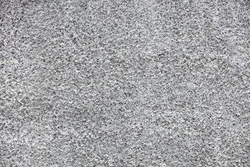 Texture and background of gray facade plaster with fine and sharp cement granules.