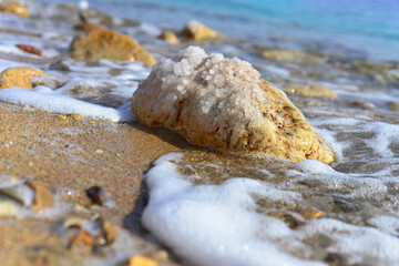 Close up of salt background. Natural salt. Dead Sea salt mineral natural formations. Salt crystals from Dead sea. View of Dead Sea coastline. Texture of Dead sea. Salty seashore rocks