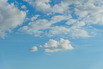 abstract background of white fluffy clouds on a bright blue sky