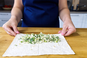 Pita with aggs and onion. chef prepares edible snacks for party. close up