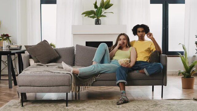 Modern multiethnic unstereotyped couple lifestyle moments at home. Not stereotyped boyfriend and girlfriend living together. True love concepts