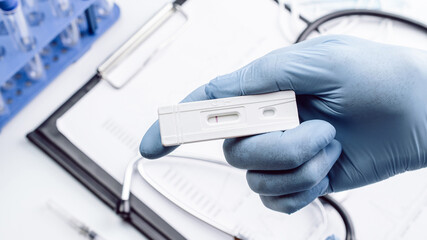 Covid test antigen coronavirus kit. Doctor holding rapid covid medical test. Laboratory hospital...