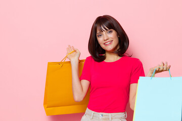 Fototapeta premium beautiful woman pink t-shirts with shopping bags cropped view