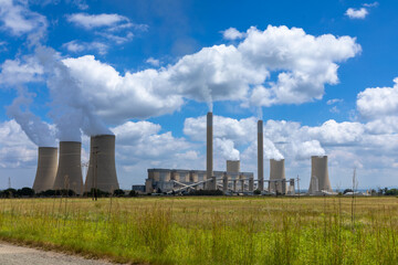 Fototapeta na wymiar Working coal fired power station in South Africa. Grass field in the foreground