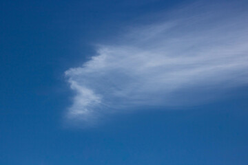 Beautiful sky background. Unusual cirrus clouds in the blue sky