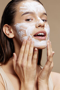 young woman skin care by using white mask on the face close-up make-up