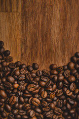 Coffee beans roasted on wooden background Close up macro copy space