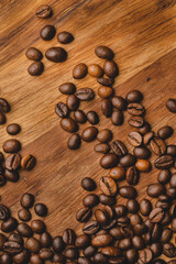 Coffee beans roasted on wooden background Close up macro copy space