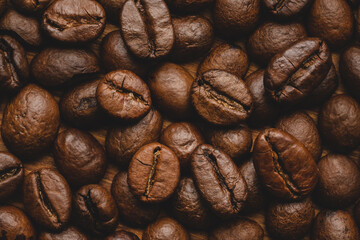 Coffee beans roasted full frame background Close up macro dark brown