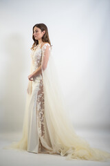 Fototapeta premium Beautiful bride in a magnificent white wedding dress of tulle with corset lacing and long beauty hair