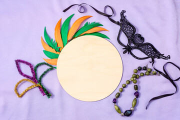 Mardi Gras Mockup, Wooden empty round sign template with copy space and black mask, beads, colorful...