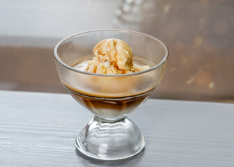 vanilla ice cream with coffee expresso  on a café table 
