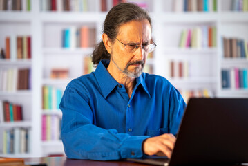 Angry stressed businessman reading bad news on laptop. Mad man feels frustrated about high bills, dismissal notice, bank debt, tax invoice or mistake sits at home office desk.