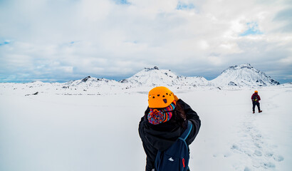 Fototapeta na wymiar Snow covered mountains in Iceland with group of Mountain Hikers