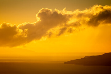 Wonderful colors sunset on the ocean with clouds and islands insilhouette in background. Concept of summer holiday vacation and timeless nature
