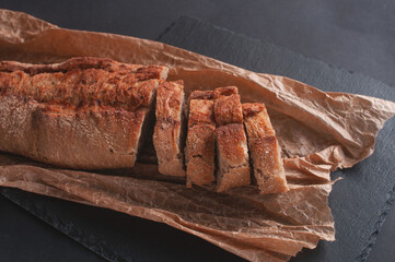 cereal baguette cut into pieces on parchment paper