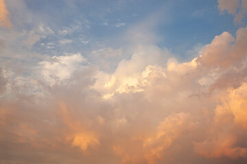 Beautiful cloudscape with orange and gray tones and blue sky at sundown