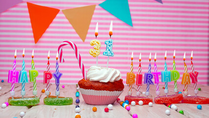 Thirty-one year happy birthday card on a pink background, with a number in a cupcake. Beautiful...