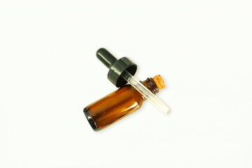 essential oil bottle with dropper in white background with copy space for health,medical,perfume,herbal related concept
