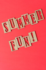 sign with the words "summer fun!" in wooden stencil type on paper