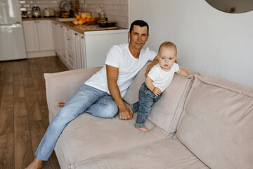 first steps, dad with baby on the couch