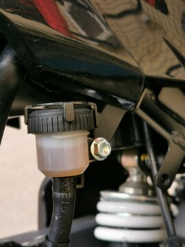 Close up image of motorcycle brake fluid tank reservoir.