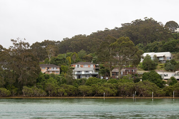 Fototapeta na wymiar Houses and tree around the lake side.