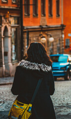 Brunette Girl Walking Down Street in Fur Jacket