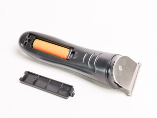 Rechargeable hair clipper with battery against white background.