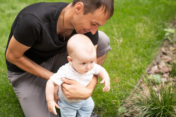 Fototapeta premium Father and his son walking at summer park