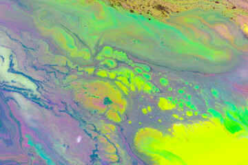 Gold texture on fluorescent paints mix flow background.