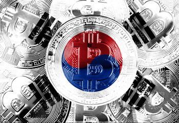 Holds a physical version of Bitcoin and the South Korean flag. Concept map of South Korean cryptocurrency and blockchain technology. Double exposure creative bitcoin symbol hologram. 