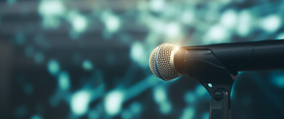 Microphone Public speaking background, Close up microphone on stand for speaker speech presentation stage performance with blur and bokeh light background.